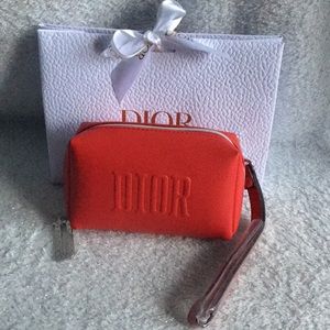 Dior Beaute vanity case with non branded removable wristlet strap.